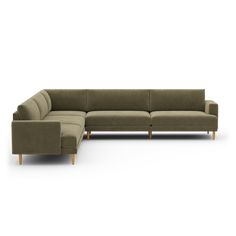 a large sectional couch sitting on top of a white floor next to a footstool