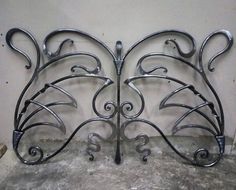 a metal headboard made to look like a butterfly