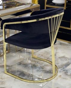 a chair that is sitting in front of a mirror with gold trimmings on it