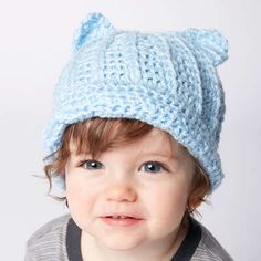 a small child wearing a knitted hat