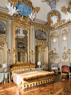 an ornately decorated bedroom with gold and blue walls