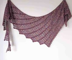 a crocheted shawl hanging on the wall