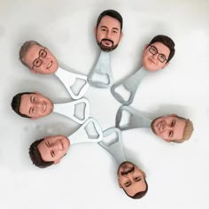 a group of people with fake heads in the shape of a circle