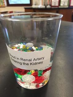 a cup filled with candy sitting on top of a table