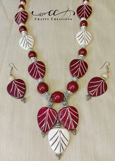 "Experience the timeless elegance of our \"Chic Red & White Beaded Handmade Necklace and Earrings Set.\" This exquisite jewelry ensemble beautifully blends the classic charm of red and white, featuring a stunning necklace and coordinating earrings that radiate sophistication and style. Necklace Details: Step into a world of refined beauty with this handcrafted necklace, meticulously designed to capture the allure of red and white. Each bead is carefully selected, creating an enchanting pattern that catches the eye.  Earrings Details: The matching beaded earrings mirror the necklace's captivating design, adding a touch of elegance to your ensemble. Suspended from hypoallergenic ear wires, these earrings sway delicately, reflecting light with every movement.  Craftsmanship: Our skilled artis Festive Red Artisan Jewelry, Festive Artisan Red Jewelry, Handmade Red Temple Jewelry Set, Handmade White Beads For Festive Season, Handmade Silver Temple Jewelry Beads, Handmade Temple Jewelry Beaded Necklaces For Festivals, Handmade Red Jewelry Sets For Festive Occasions, Handmade Red Jewelry Sets For Festive Season, Handmade White Festive Beads