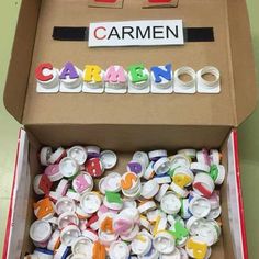 a cardboard box filled with lots of different colored letters