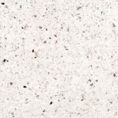 a close up view of a white marble counter top with black and gray speckles