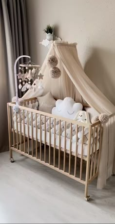 a baby crib with stuffed animals in it and a canopy over the crib