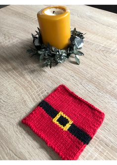 a knitted square with a candle on it