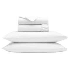 white sheets and pillows stacked on top of each other in front of a white background