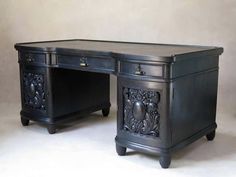 an ornate black desk with two drawers