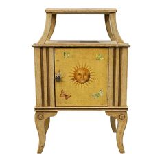 a small wooden cabinet with sun and butterflies painted on it's doors, side view