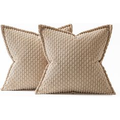 two beige pillows sitting next to each other