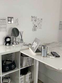 a white desk topped with lots of clutter next to a mirror and other items