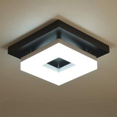 a square light fixture is suspended from the ceiling