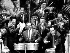 a group of men in suits and ties posing for a photo with musical instruments behind them