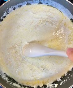 someone is mixing batter in a pan on the stove