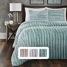 a bed with white and blue comforters in a bedroom