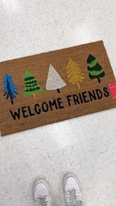 someone standing in front of a welcome mat with trees on it and the words welcome friends