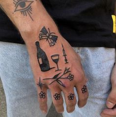 a man's hand with tattoos on it