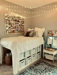 a white bed sitting in a bedroom next to a dresser