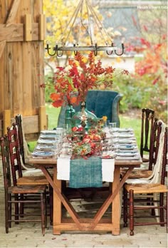 an open magazine with a table and chairs on it's cover, in front of a wooden fence