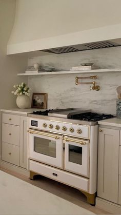 a white stove top oven sitting inside of a kitchen next to cabinets and counter tops