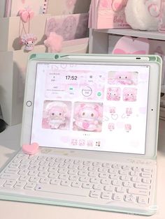 an open laptop computer sitting on top of a white desk next to a stuffed animal