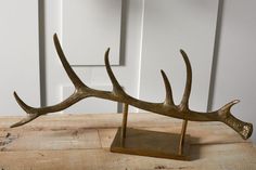 an antler is standing on a wooden table