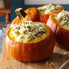 three stuffed pumpkins on a wooden cutting board