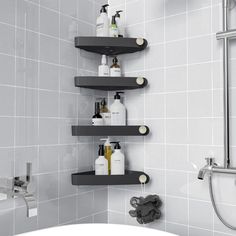 a bathroom with three shelves on the wall