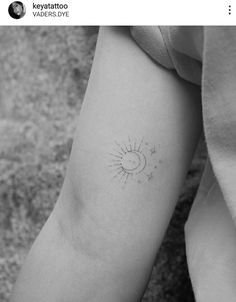 a small sun and stars tattoo on the arm