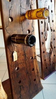 two wine racks made out of wood with bottles on them