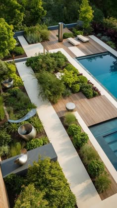 an aerial view of a pool surrounded by greenery