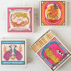 four matchboxes with different designs on them