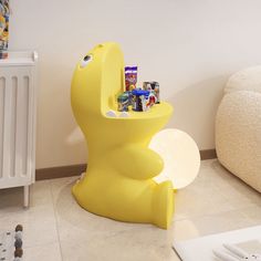 a yellow chair with cans in it sitting on the floor next to a radiator