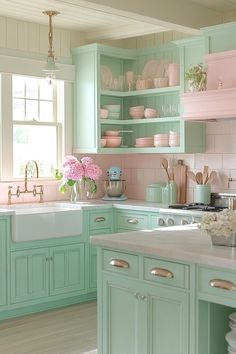 a kitchen filled with lots of green cabinets