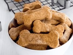 homemade dog treats in a white bowl on a cooling rack with the words homemade dog treats