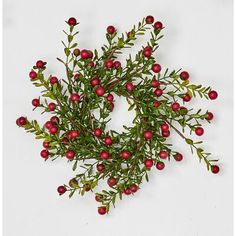 an arrangement of red berries and green leaves