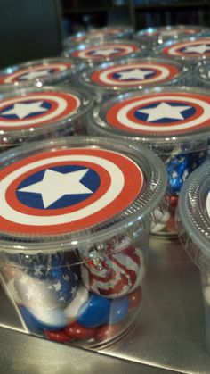 plastic containers filled with candy and captain america themed candies on a metal counter top