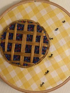 a close up of a piece of art on a table with some bees around it