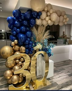 balloons and decorations in the shape of numbers are on display at a 50th birthday party