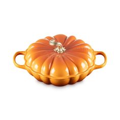 an orange pumpkin shaped casserole on a white background