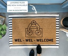 a welcome mat with an image of a person standing on the floor next to it