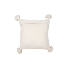 a white pillow with pom - poms on the front and back of it