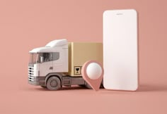 a white truck next to a cardboard box with a pink marker in front of it