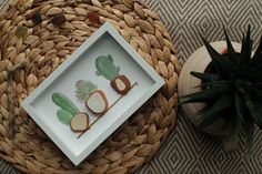 an arrangement of sushi on a table next to a basket and potted plant