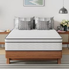 an image of a bedroom setting with mattresses and pillows on the side table in front of the bed