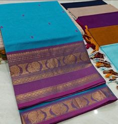 This saree comes with beautiful kanchivaram style gold/copper zari woven borders on chettinad cotton with body woven buttas. Pallu has simple and elegant stripes with buttas. These sarees are a fusion of Chettinad Cottons sarees with Kanchivaram style copper/gold zari woven borders. Running Blouse (5.5 + 0.7 m) Fall and pico - not done Purple Cotton Traditional Wear With Zari Work, Blue Cotton Handloom Traditional Wear, Blue Cotton Saree For Diwali, Blue Cotton Dupatta With Zari Weaving, Blue Cotton Saree With Pallu, Purple Cotton Traditional Wear With Cutdana, Blue Cotton Traditional Wear With Printed Border, Blue Cotton Saree For Navratri, Blue Cotton Traditional Wear For Puja