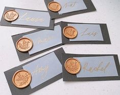 four silver and gold place cards with coins on them